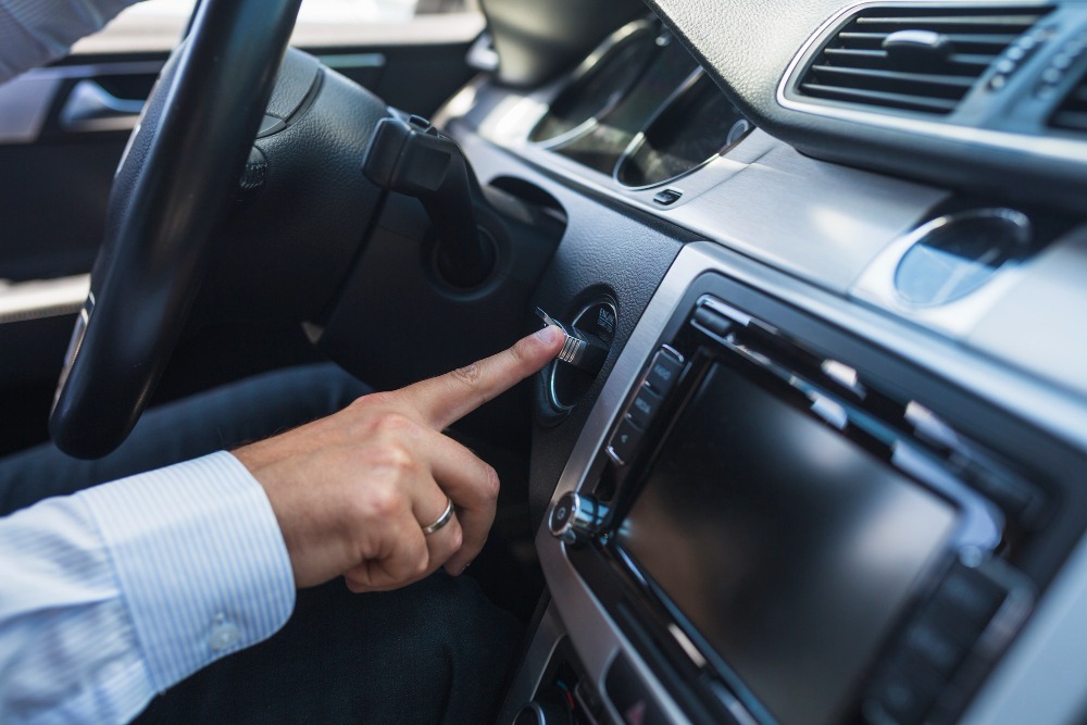 a person sitting inside the car driving the steer wheel